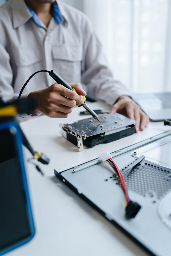 technician fixes computer PC components in a technical lab